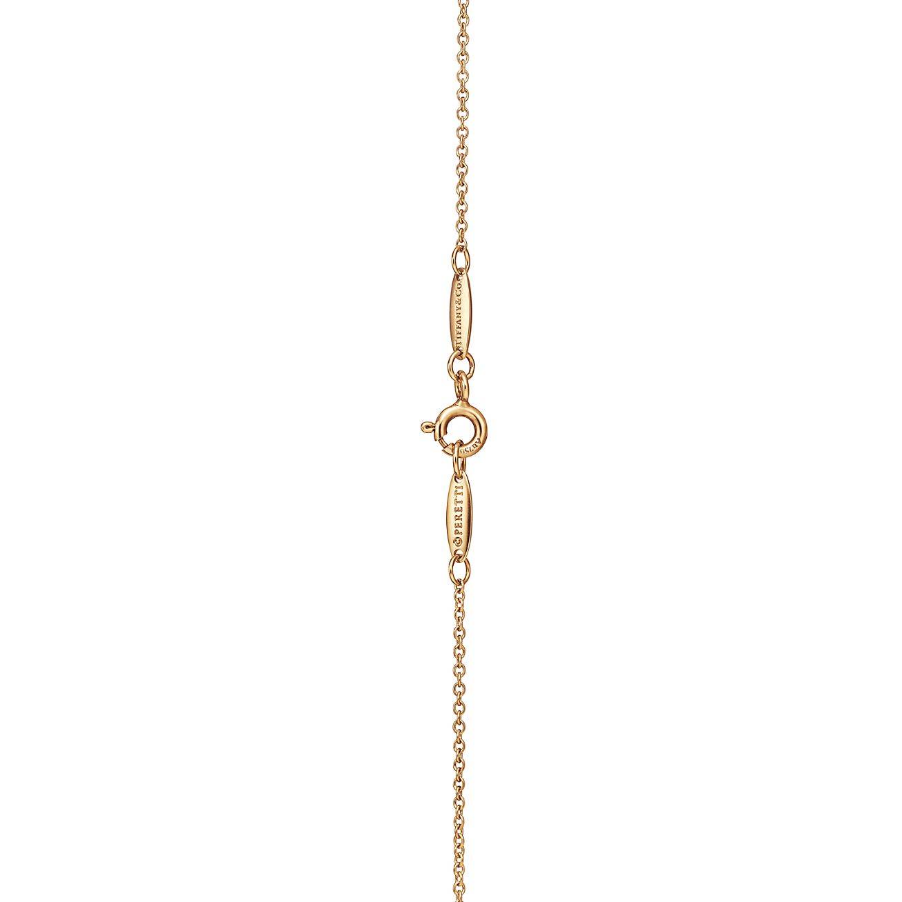 TIFFANY  ELSA PERETTI® OPEN HEART PENDANT IN YELLOW GOLD WITH EMERALDS, 16 MM